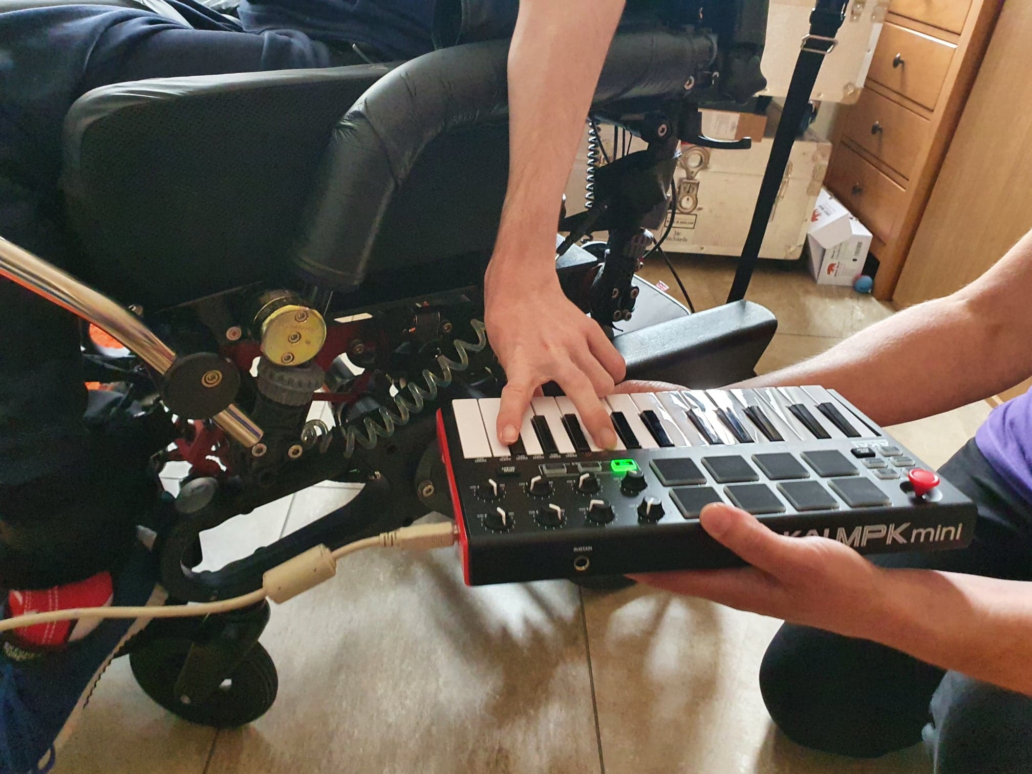 Outreach Music Studio - keyboard midi controller being played by disabled musician.